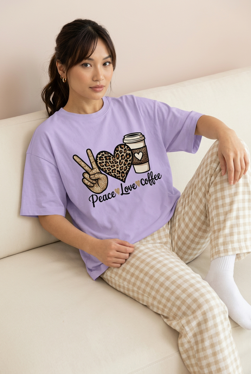 Lavender coffee graphic tee with checked pajama pants, sofa pose
