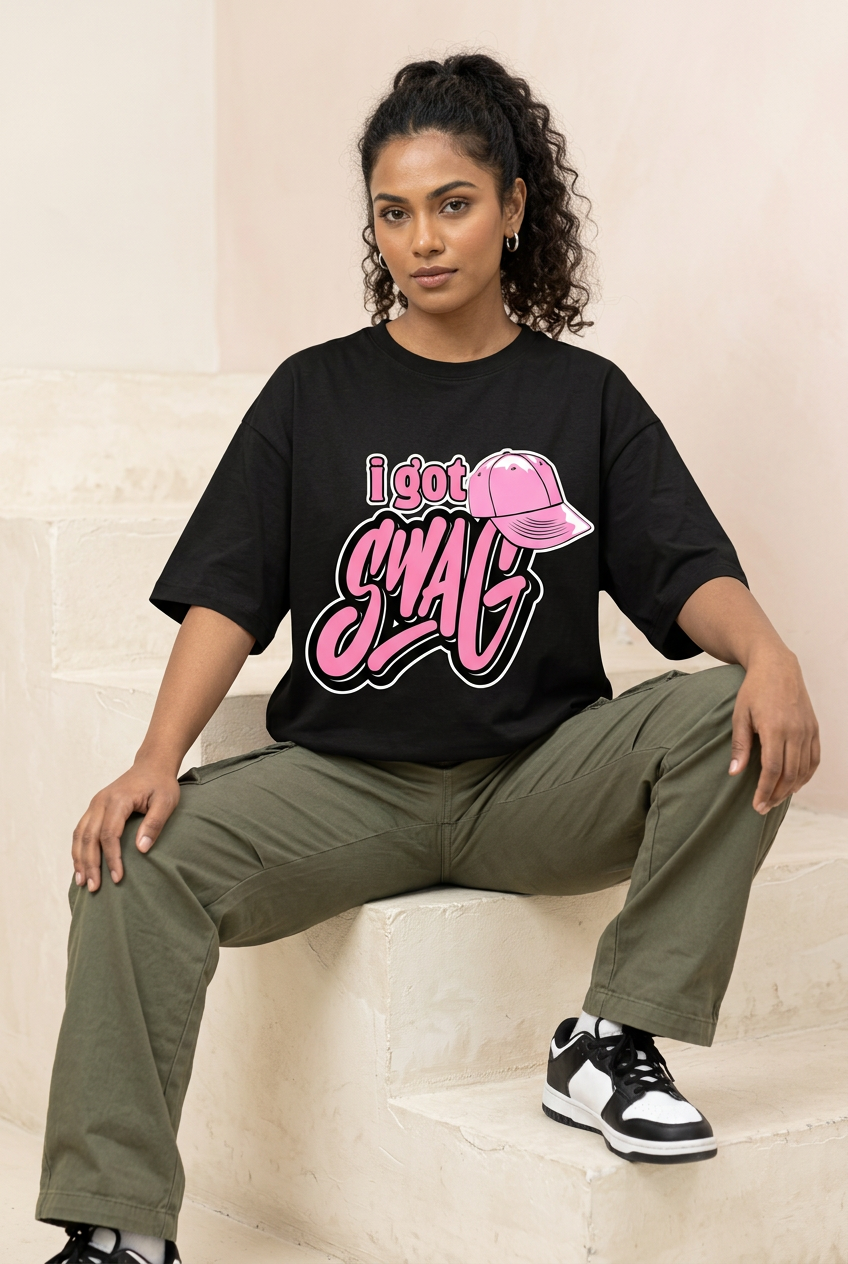 Pink I Got Swag oversized tee with olive cargo pants, seated pose